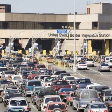 Cars queued at United States border inspection station.