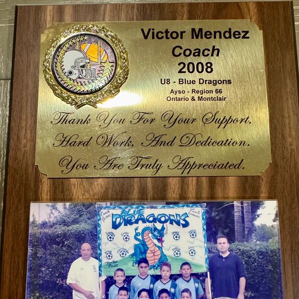 Coach plaque and youth soccer team photo.