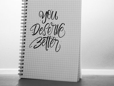 notebook with You Deserve Better printed on cover
