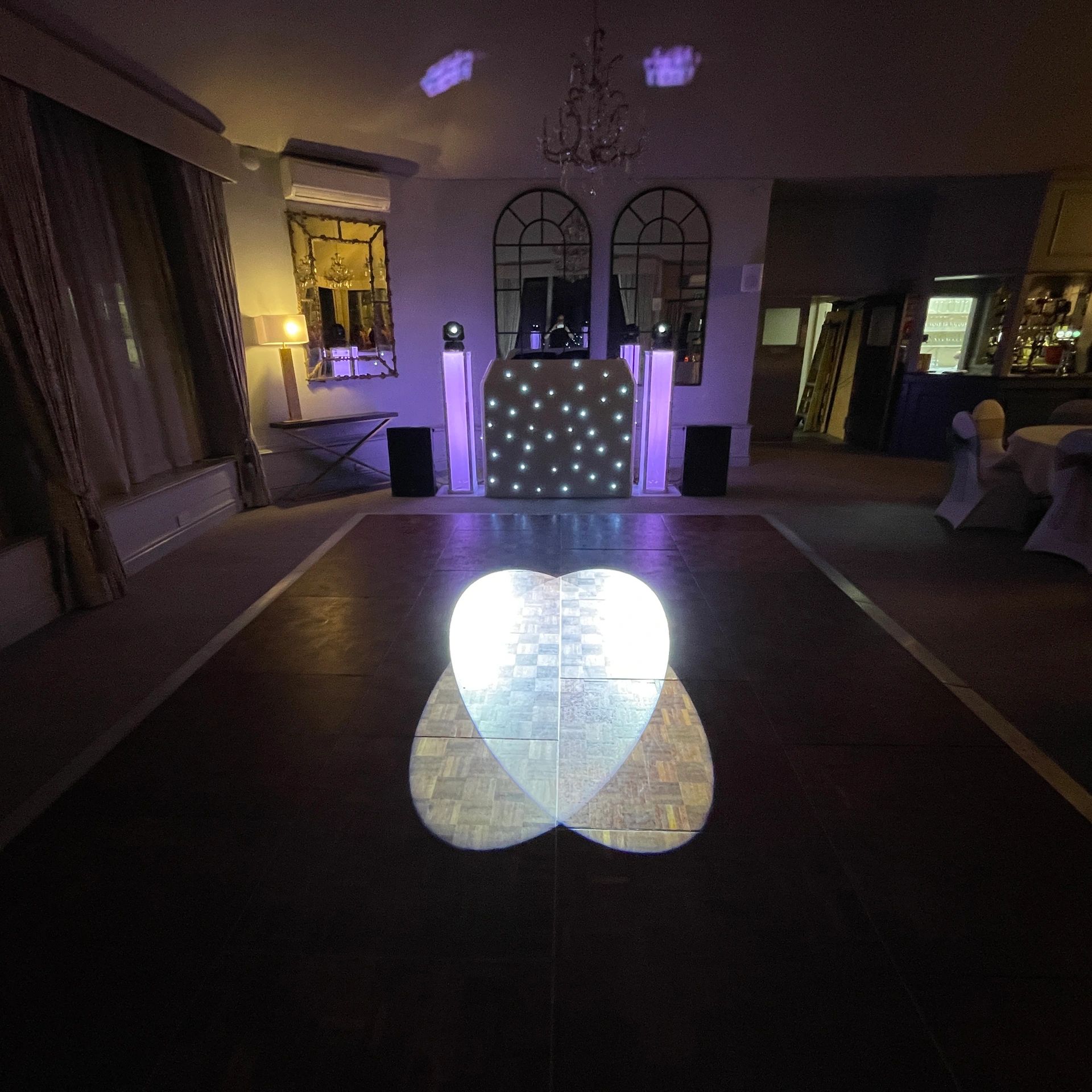 NSC Entertainment wedding DJ setup with starcloth booth and colourful lighting