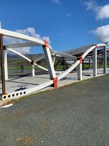 Steel frame structure under construction outdoors.