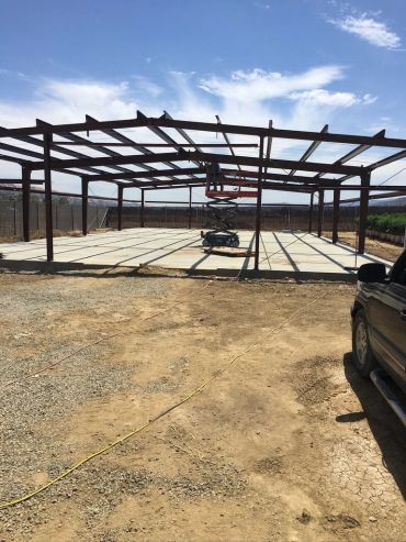 Steel frame construction with a scissor lift inside.