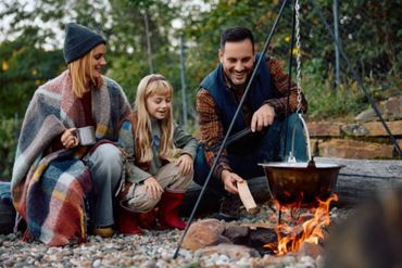 Family enjoying a cozy campfire outdoors with a cooking pot.“No one does comfort food better. The Best Soup Company delivers gourmet soups that feel homemade, rich, and incredibly satisfying.” Get on our soup delivery subscription list.