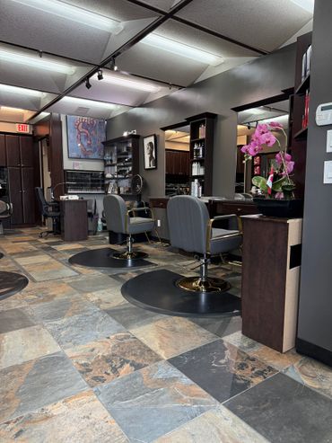 Modern salon interior with styling chairs and artistic decor.