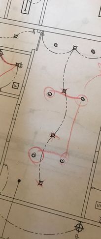 Electrical wiring plan with red markings on blueprint.