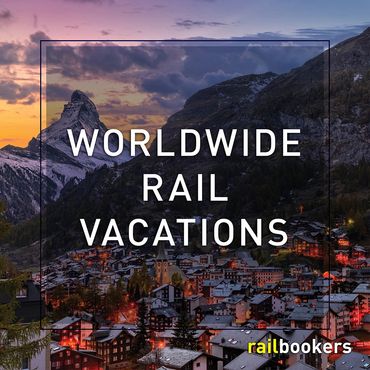 Scenic mountain village at dusk promoting worldwide rail vacations.