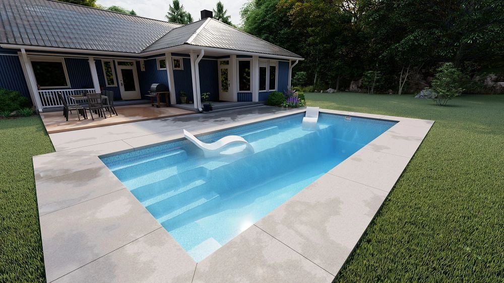Modern backyard with a rectangular pool and lounge chair.