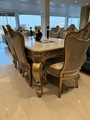 Elegant dining table with ornate chairs