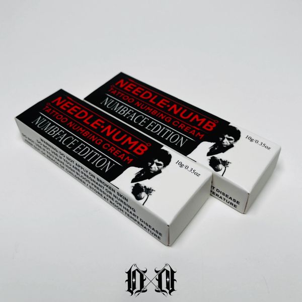 Two boxes of Needle-Numb tattoo numbing cream.