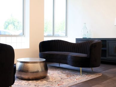 lobby with big windows and large black couches