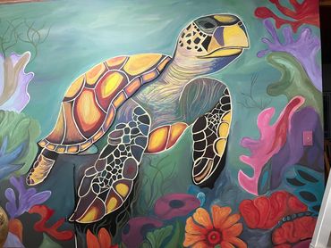 Colorful sea turtle mural surrounded by vibrant coral and flowers.