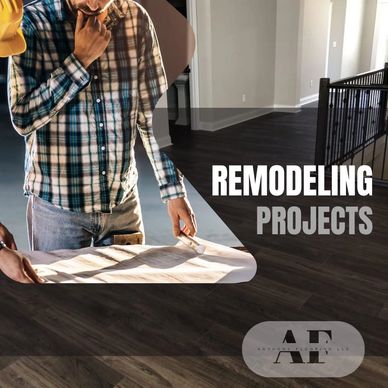 Two contractors reviewing blueprints for a remodeling project indoors.