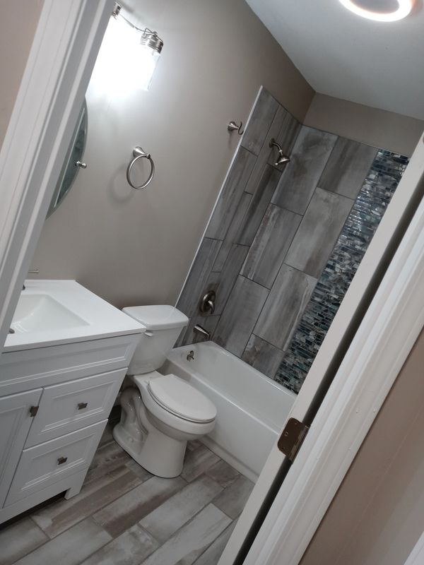 bathroom renovation tile flooring vanity plumbing electrician lighting upgrade toilet install design