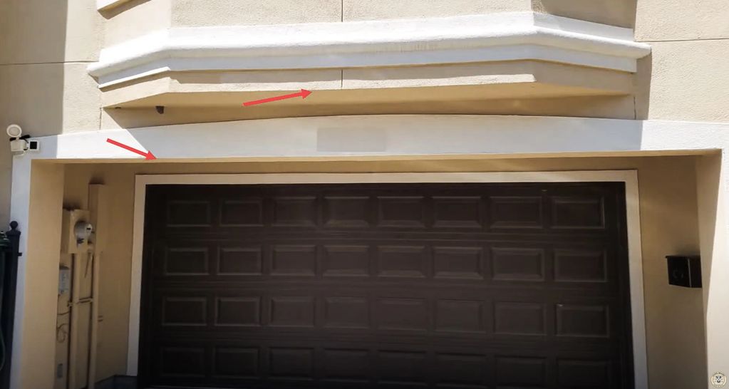 Garage entrance, showing a smooth surface with some discoloration.