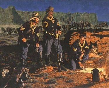 Three soldiers in uniform camping in a desert at night.