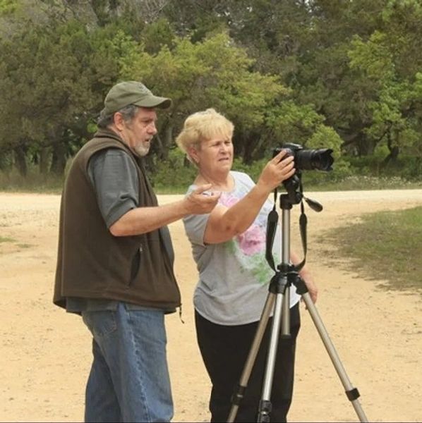 Real-time coaching: dialing in camera settings on a tripod during an outdoor class.