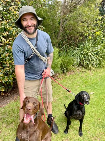 Dog trainer Chris Burke with two German short-haired pointers after dog recall training.