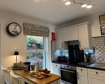 Cozy kitchen nook with breakfast setup and patterned backsplash tiles.