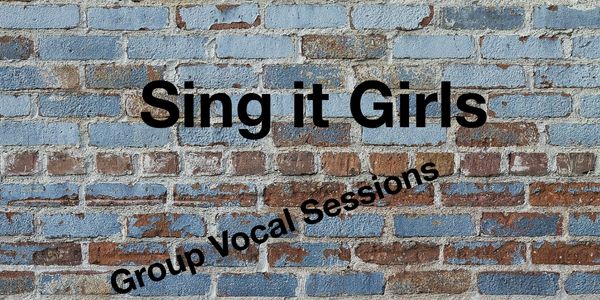 Text on a brick wall saying 'Sing it Girls' and 'Group Vocal Sessions'.