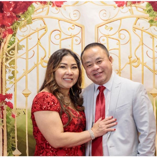 Couple smiling with decorative background.
