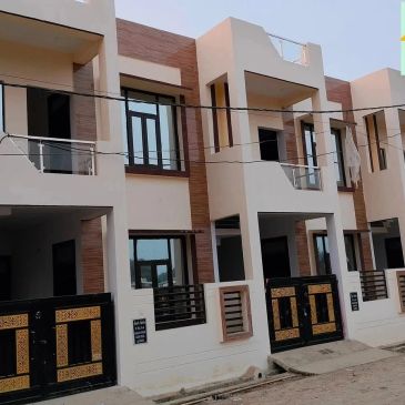 Modern row of townhouses with black and gold gates.