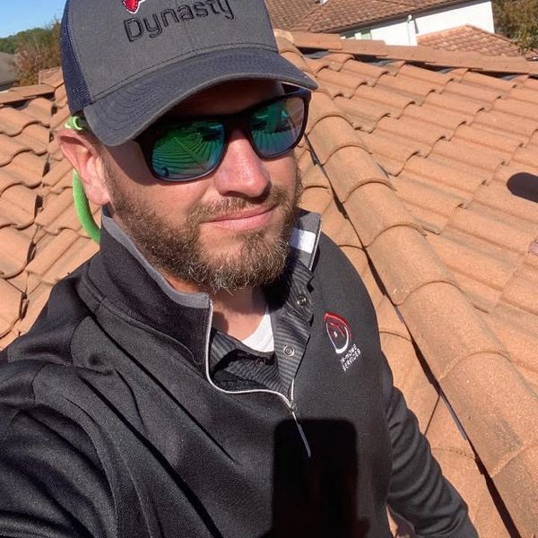 Man with sunglasses on a roof.