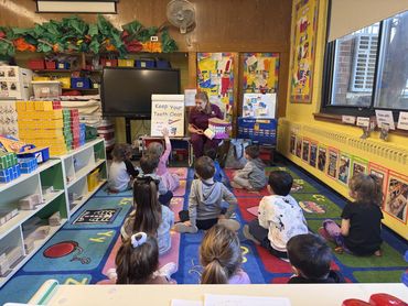 Dr. Merlino instructing children on proper dental hygiene at school visit