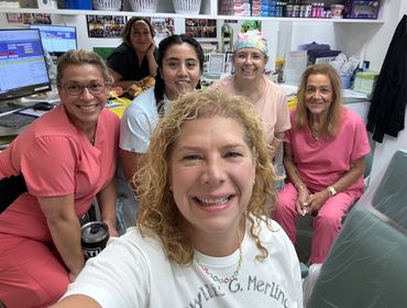 Dr. Merlino and staff smiling