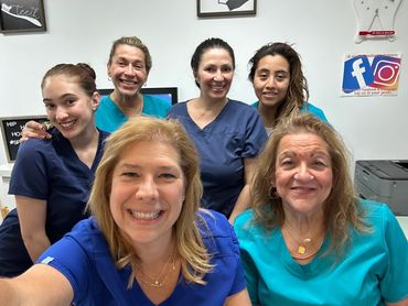 Dr. Merlino and staff smiling