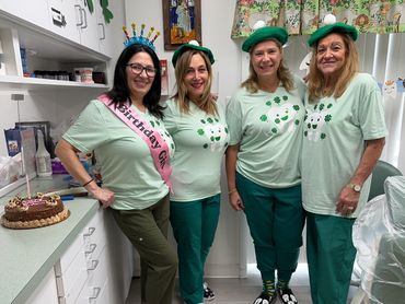Dr. Melino and staff smiling celebrating St. Patrick's Day