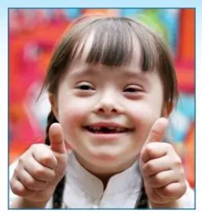 special needs dental patient giving thumbs up