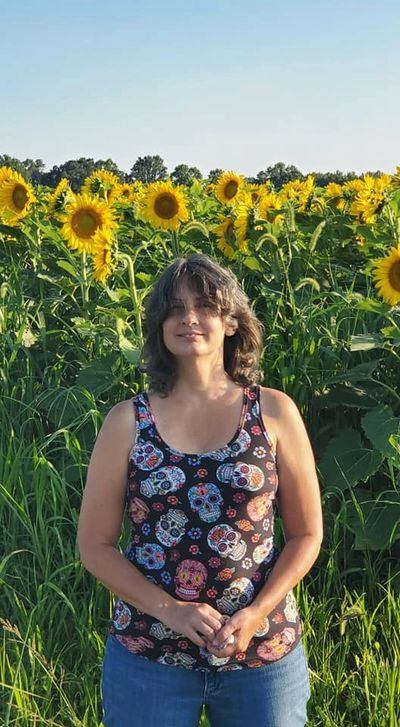 Donna in front of a field of sunflowers in Heathsville, VA. Photo by Jeff Geis, 2019