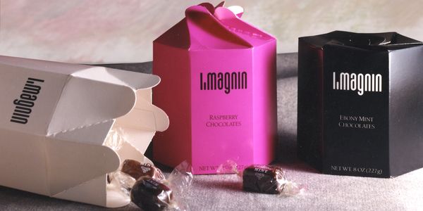 a white, pink, and black box of chocolates