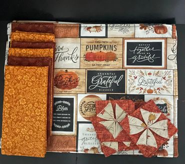 Linen and fabric squares with autumn-themed prints.