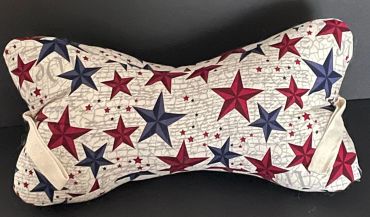 Bone-shaped pillow with red and blue stars.