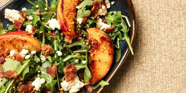 Arugula salad with peaches, bacon, and cheese.