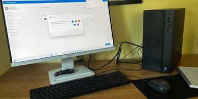 A computer setup with a Dell monitor and keyboard.