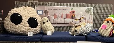 Crochet cushions shaped like sushi on a sofa.