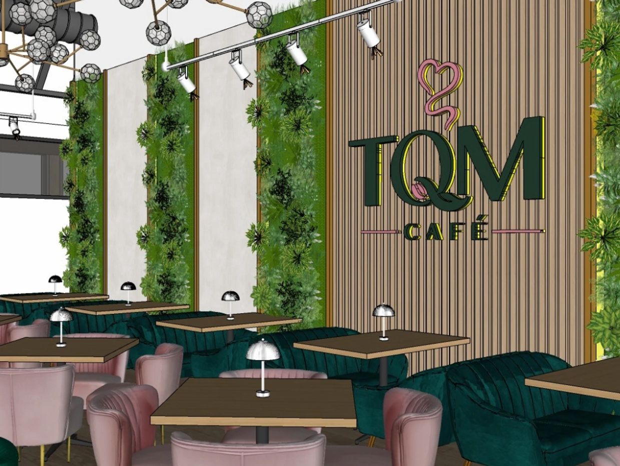 Modern café interior with green and pink seating and vertical garden walls.
