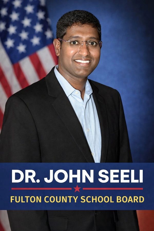 Dr. John Seeli, candidate for Fulton County School Board, posing with an American flag.