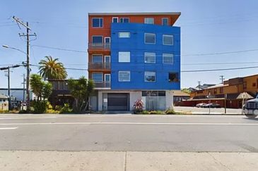 Blue Apartment Building Surrounded by Trees and Landscaping