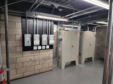 Electrical control panels and cabinets in a clean utility room.