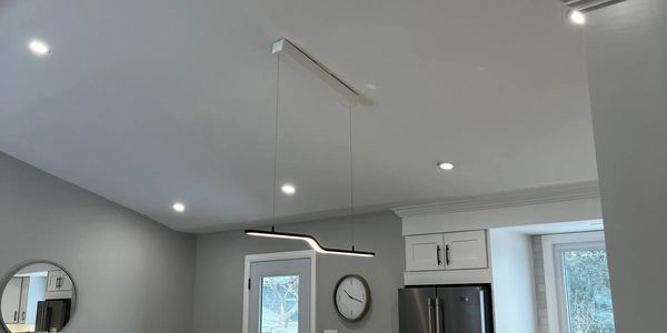 Modern kitchen with sleek lighting and minimalistic design.