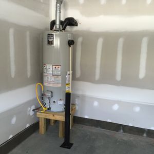 A Natural Gas water heater with a vehicular protection barrier on a new home
