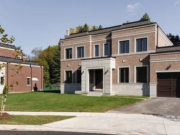 Modern brick and limestone custom home with mansard roof built in smithville nj.