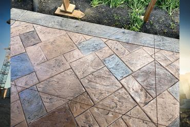 Close-up of decorative stamped concrete patio with geometric patterns.