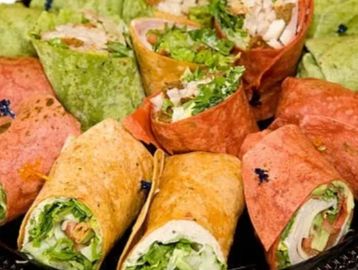 Assortment of wraps with a variety of meats, cheeses, tuna  egg salad, or veggie

