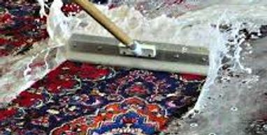 Carpet cleaning process - Rinsing: the rug is rinsed with water then placed in rubber roller wringer