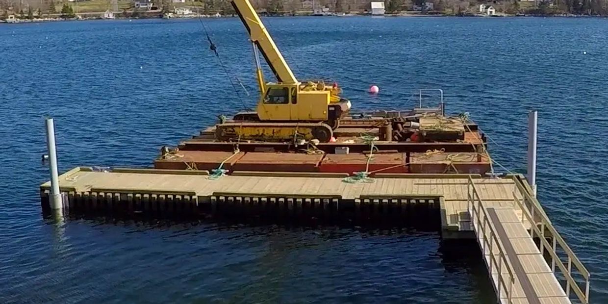 Heavy timber floating dock with pipe pilings.