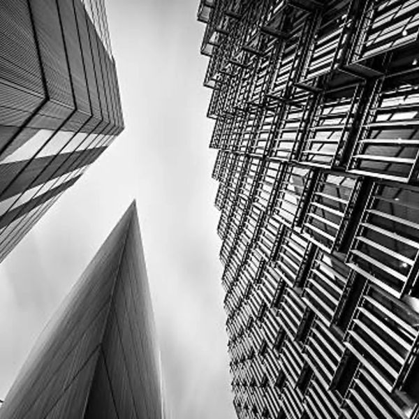 Black and white photo of modern buildings from below.